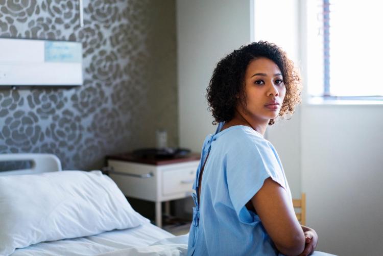 Woman in hospital gown 