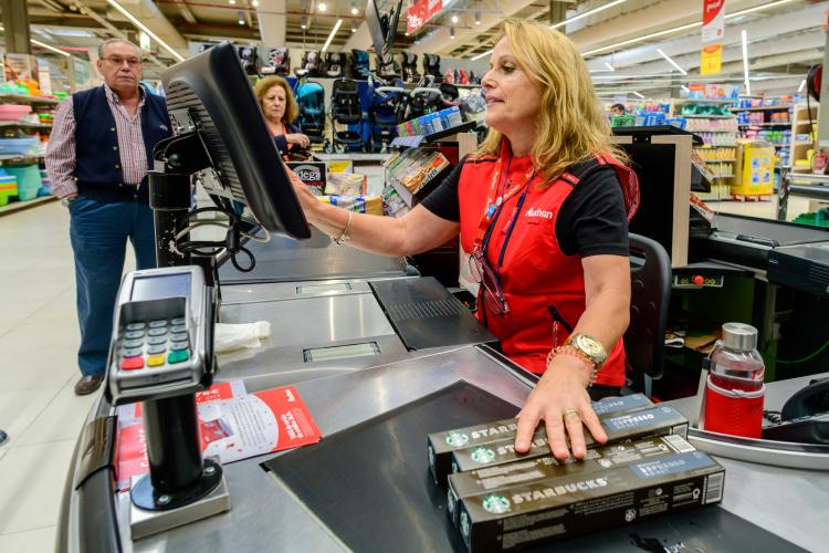 Cashier scanning items at a grocery store
