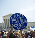 Person holding a "Keep Abortion Legal" sign 