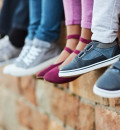 Children's legs hanging off a wall 